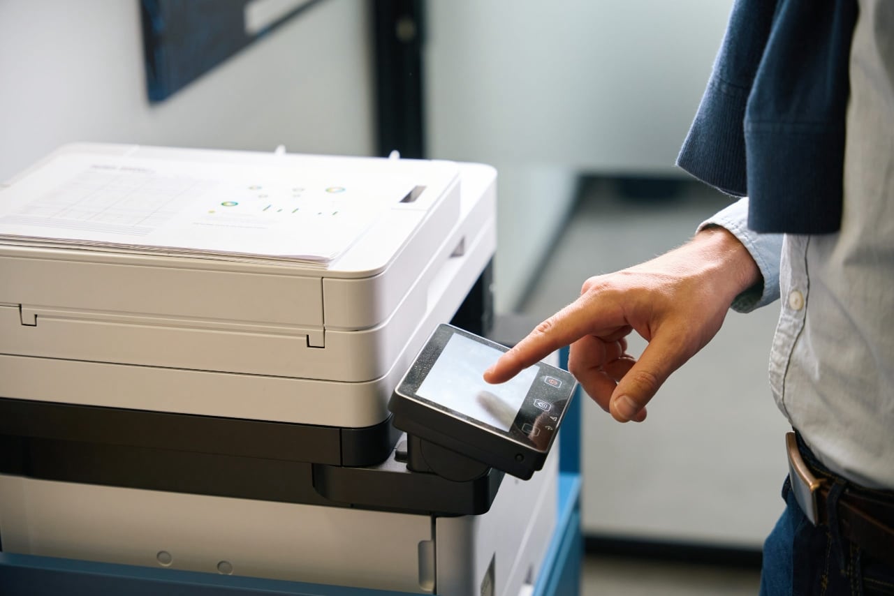 Employee uses office equipment to work with documents