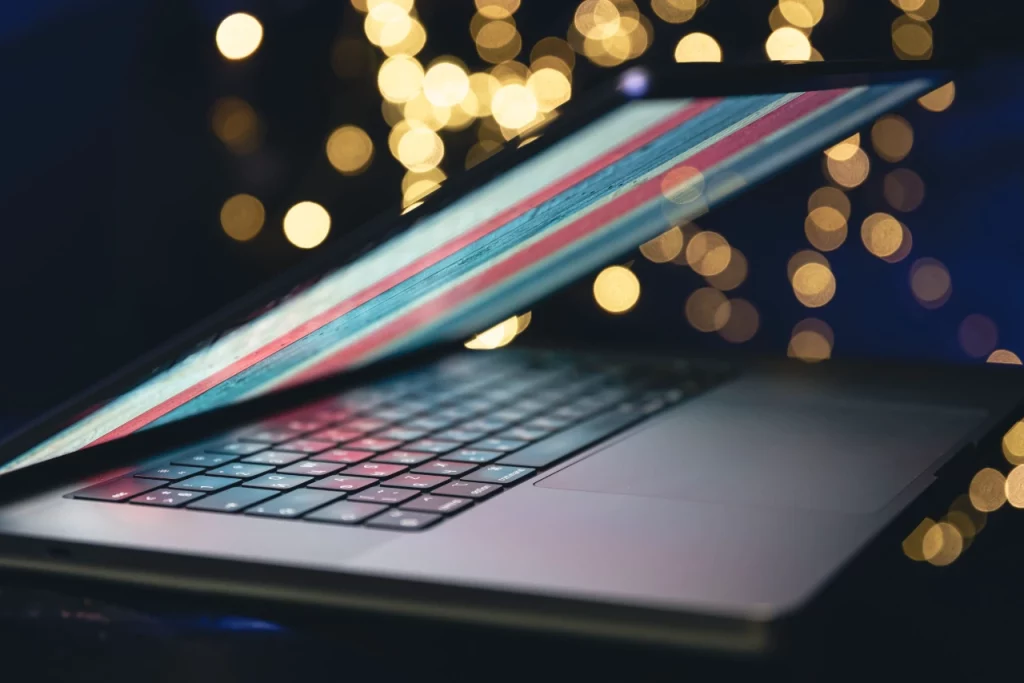 Close-up, laptop on a dark background with bokeh.